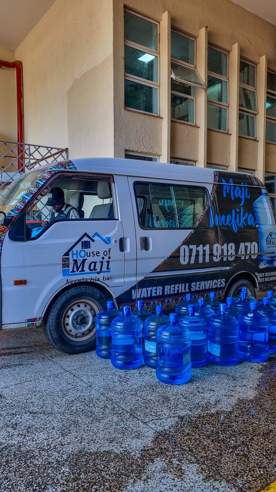 A House of Maji branded delivery van with 20-litre refill bottles — water refill services